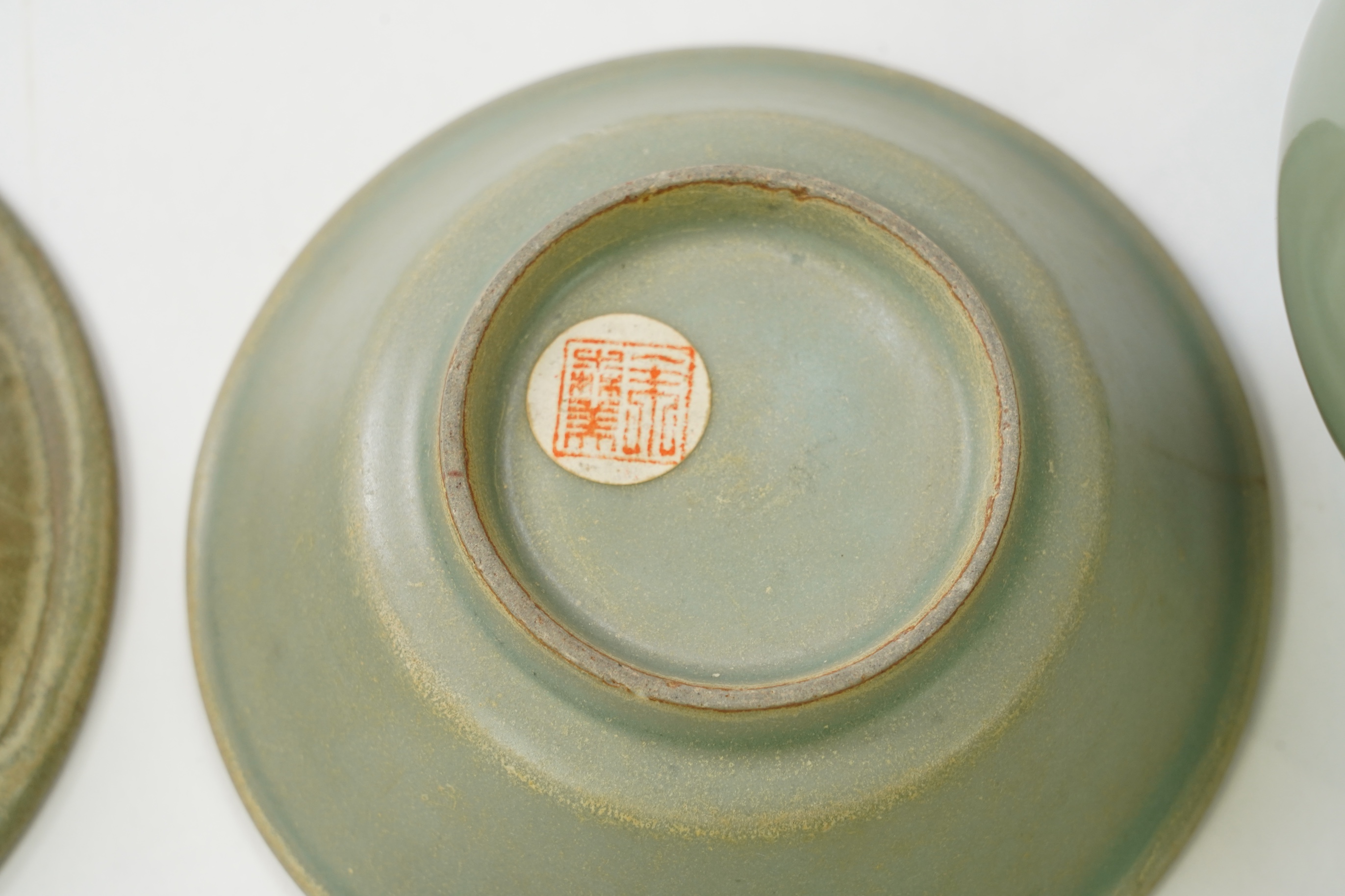 A group of four Chinese Celadon wares - two vases and two dishes, tallest vase 16cm.